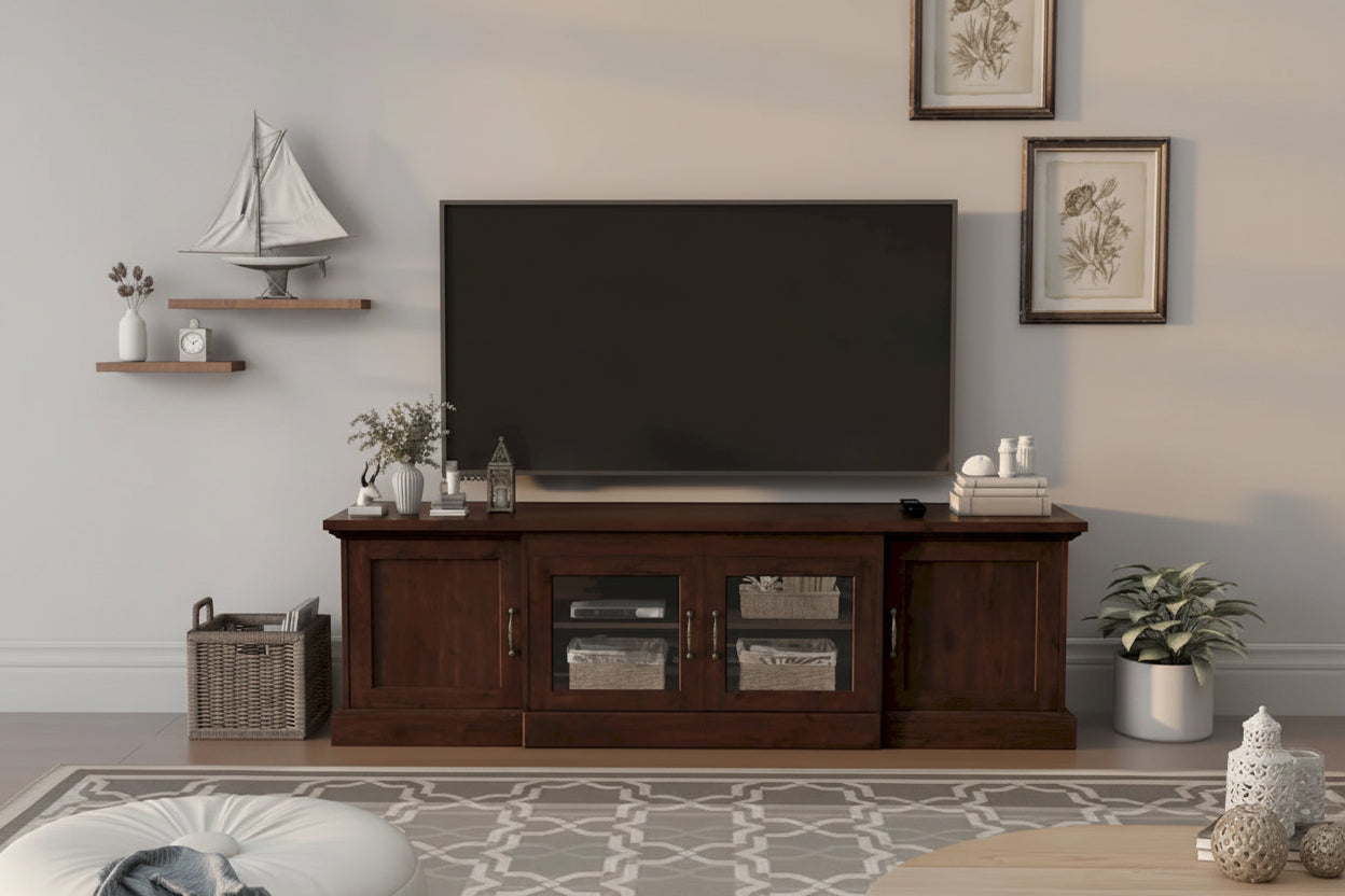 Wooden TV stand with a television in a living room setting.
